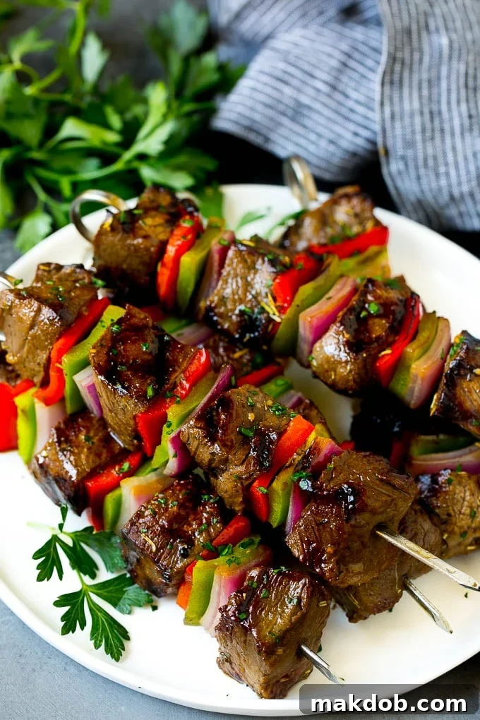 Delicious Beef Shish Kabobs with Peppers and Onions, Ready to Serve Shish kabob made with beef, peppers and onions on a serving plate.