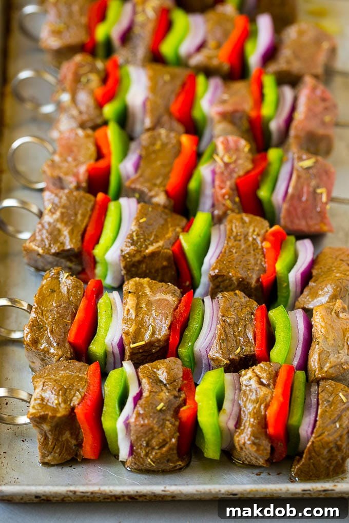 Uncooked Beef and Vegetable Kabobs Ready for Grilling Raw beef skewered with peppers and onions.