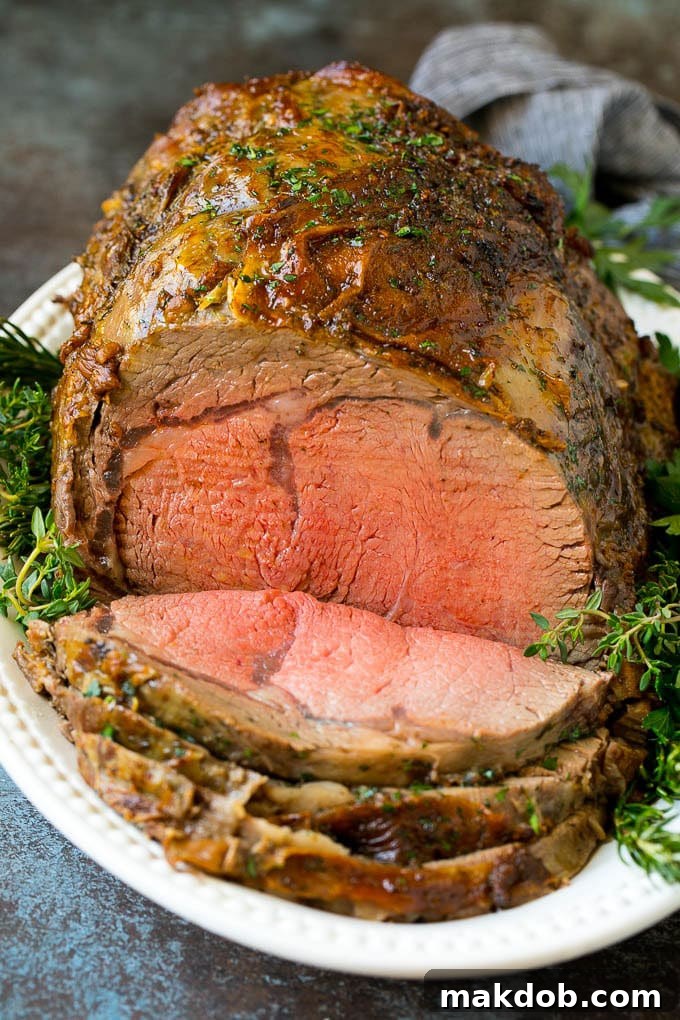 A perfectly sliced slow roasted prime rib roast, beautifully browned with a herb and garlic crust, surrounded by fresh sprigs of rosemary and thyme, resting on a wooden board. Each slice reveals a tender, juicy medium-rare interior, promising a luxurious dining experience.