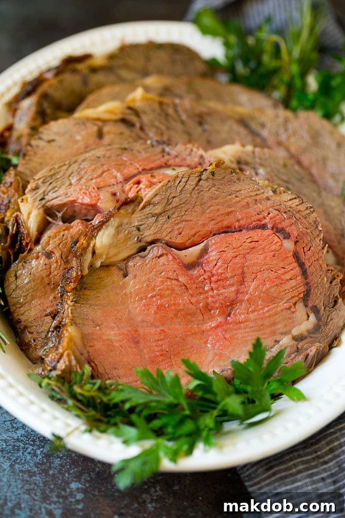 Prime Rib Recipe #primerib #beef #roast #dinner #thanksgiving #christmas #keto #lowcarb #dinneratthezoo Sliced slow roasted prime beef on a serving platter.