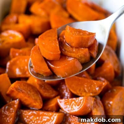 Sweet Potato Candies 7 A spoon serving up a portion of candied sweet potatoes.
