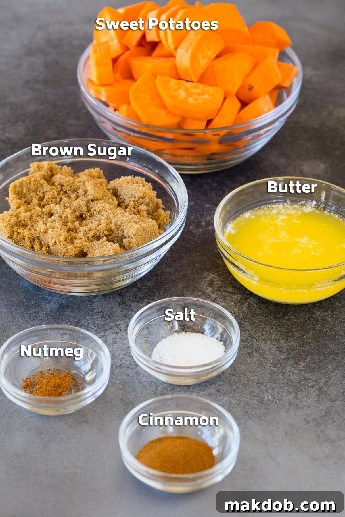 Sweet Potato Candies 3 Bowls of ingredients for candied sweet potatoes, including fresh yams, cubes of butter, brown sugar, and various seasonings.