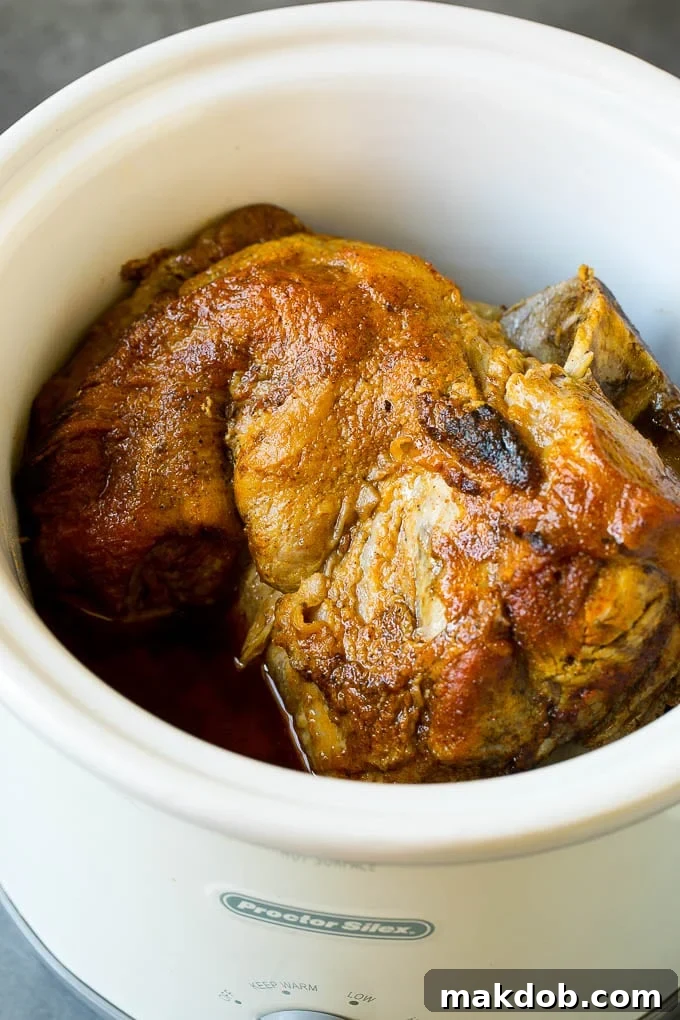 Slow Cooker Pulled Pork Recipe | Crock Pot Pulled Pork #pork #pulledpork #crockpot #slowcooker #dinner #dinneratthezoo A pork roast inside of a crock pot.