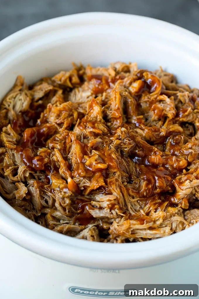 Slow Cooker Pulled Pork Recipe | Crock Pot Pulled Pork #pork #pulledpork #crockpot #slowcooker #dinner #dinneratthezoo Slow cooker pulled pork, shredded and tossed in BBQ sauce.