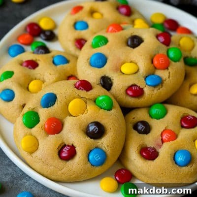 A plate of M&M cookies, garnished with extra candy.