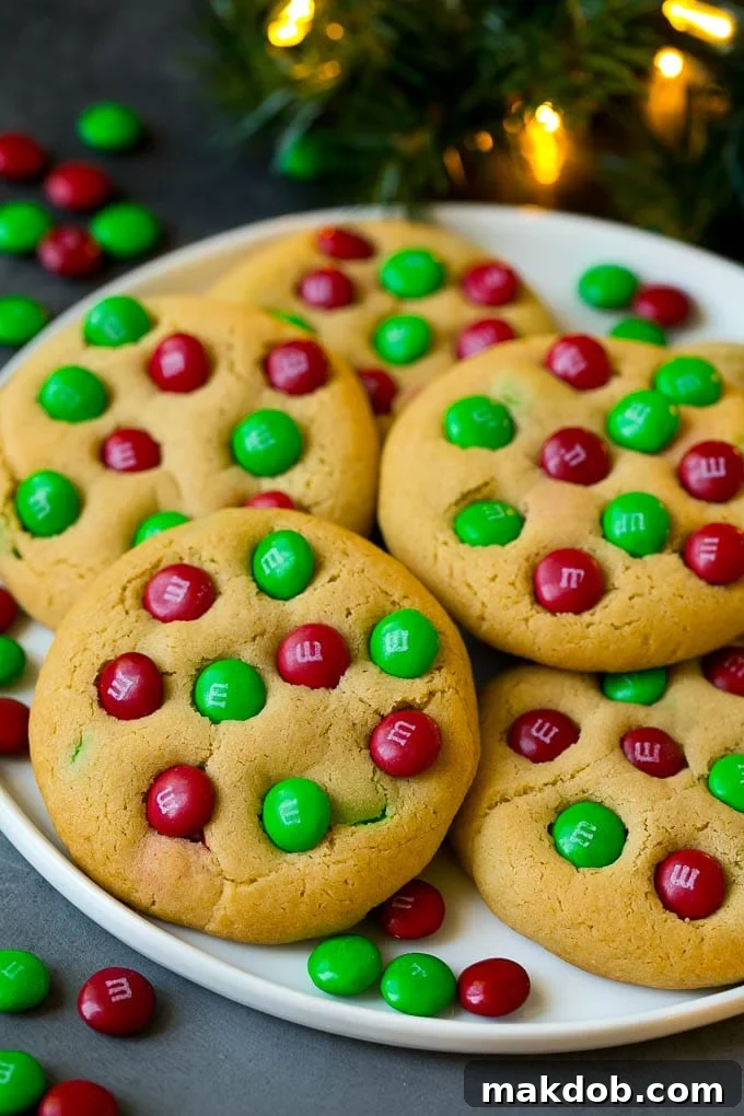 A plate of festive Christmas M&M cookies, adorned with cheerful red and green M&M candies, perfect for holiday celebrations.