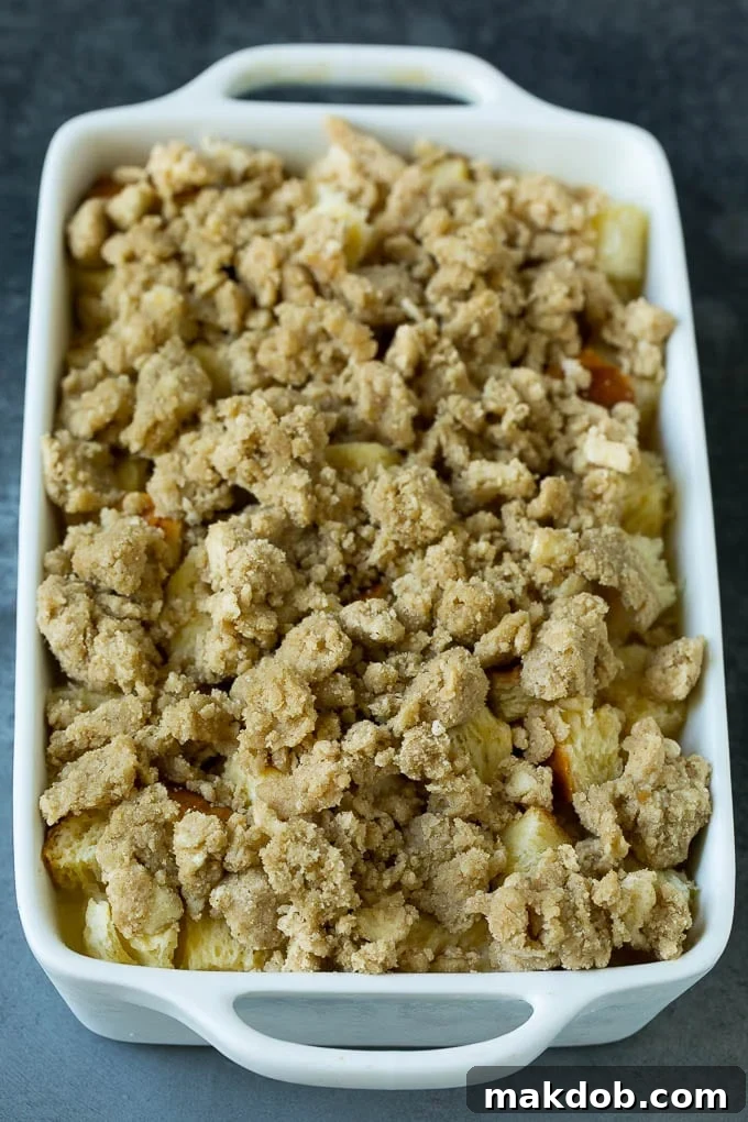 A baked French toast casserole, generously topped with golden-brown cinnamon streusel, ready to be served.