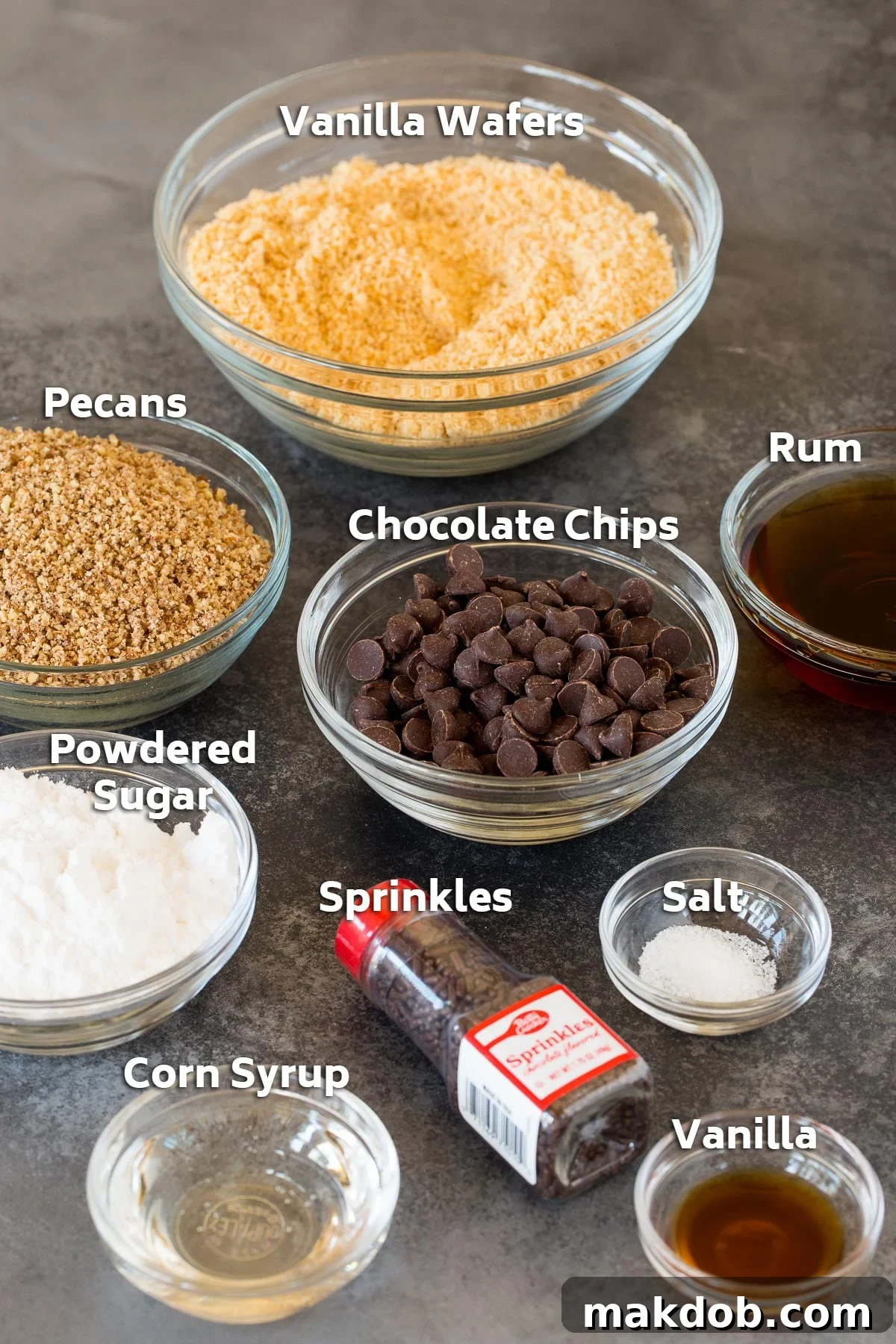 Irresistible Rum Balls 3 Bowls of rum ball ingredients including cookies, nuts, chocolate, and flavorings, neatly arranged for preparation.