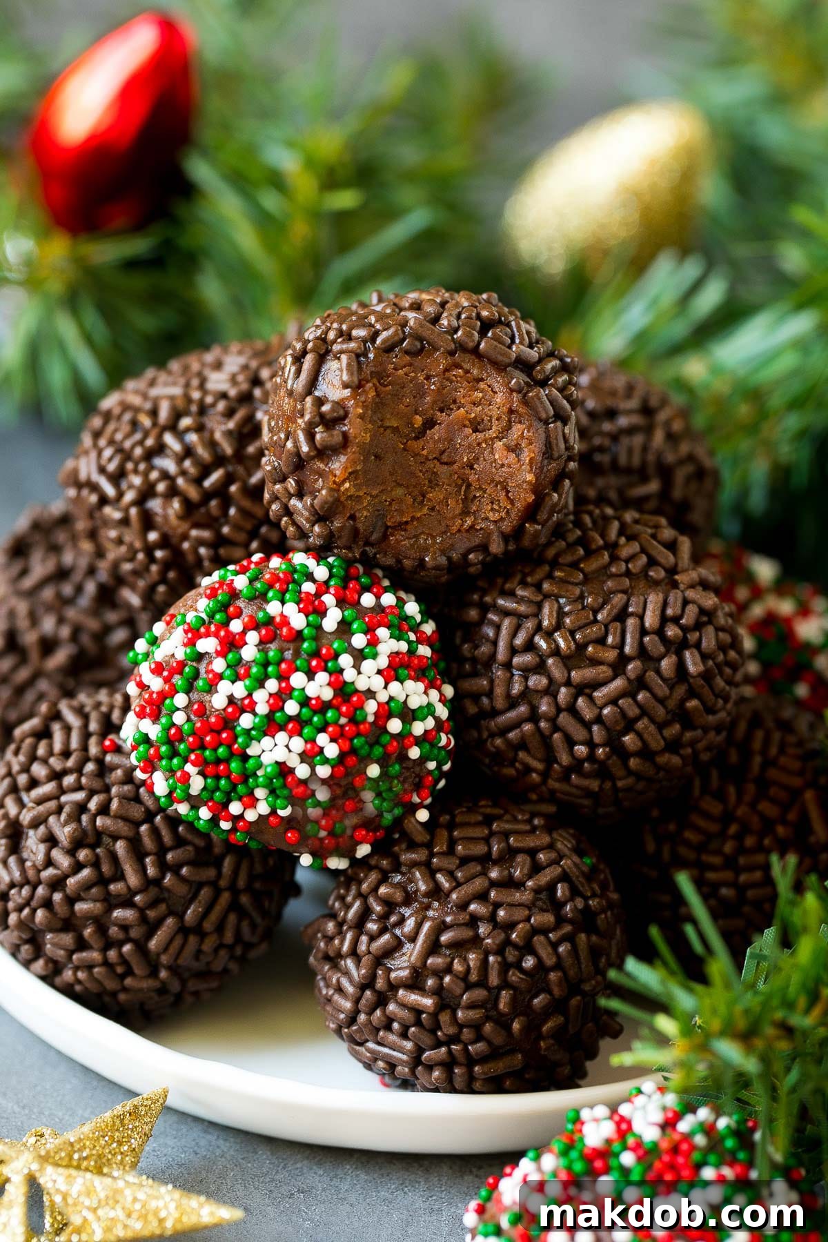 Irresistible Rum Balls 6 A plate of rum balls with holiday decorations around it, creating a festive and inviting presentation.
