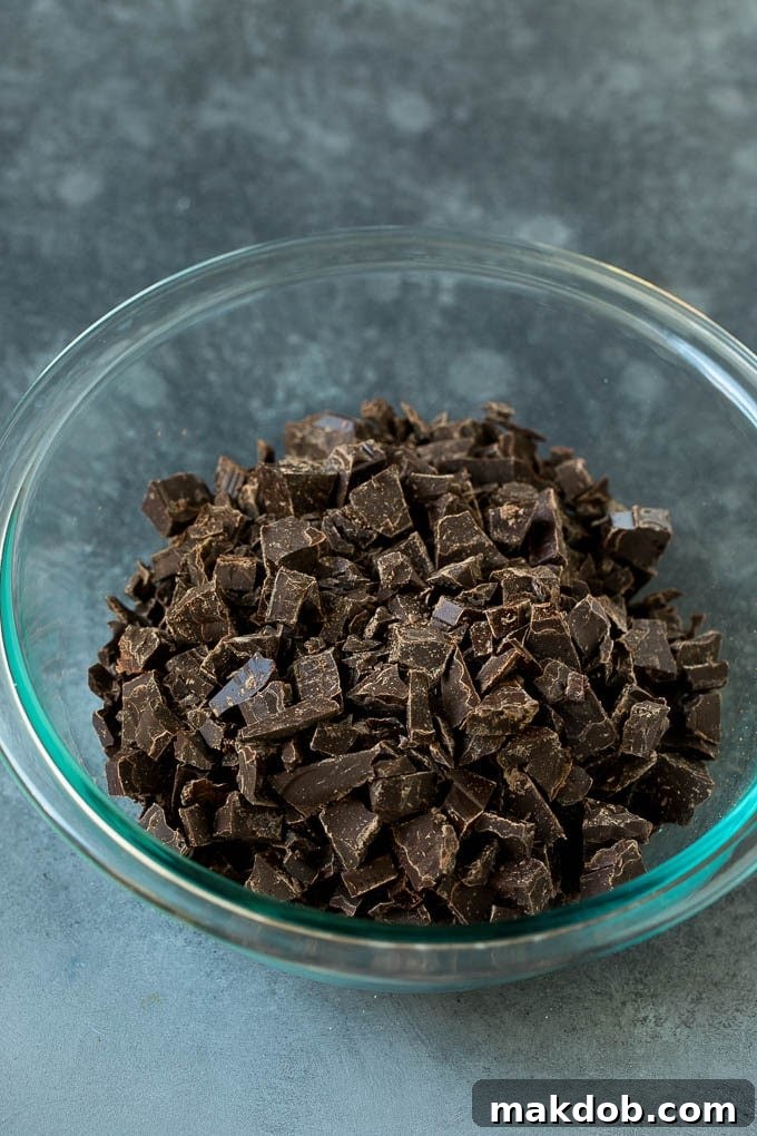 Finely chopped dark chocolate pieces ready for melting in a mixing bowl.