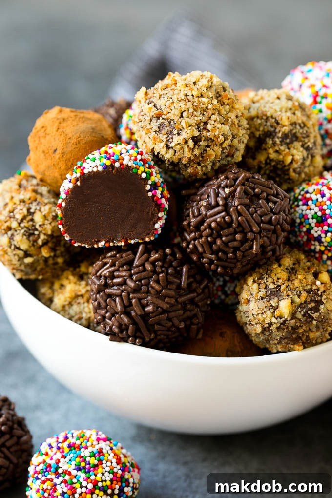 An elegant bowl filled with an assortment of homemade chocolate truffles, each coated in different toppings like cocoa, nuts, and sprinkles.