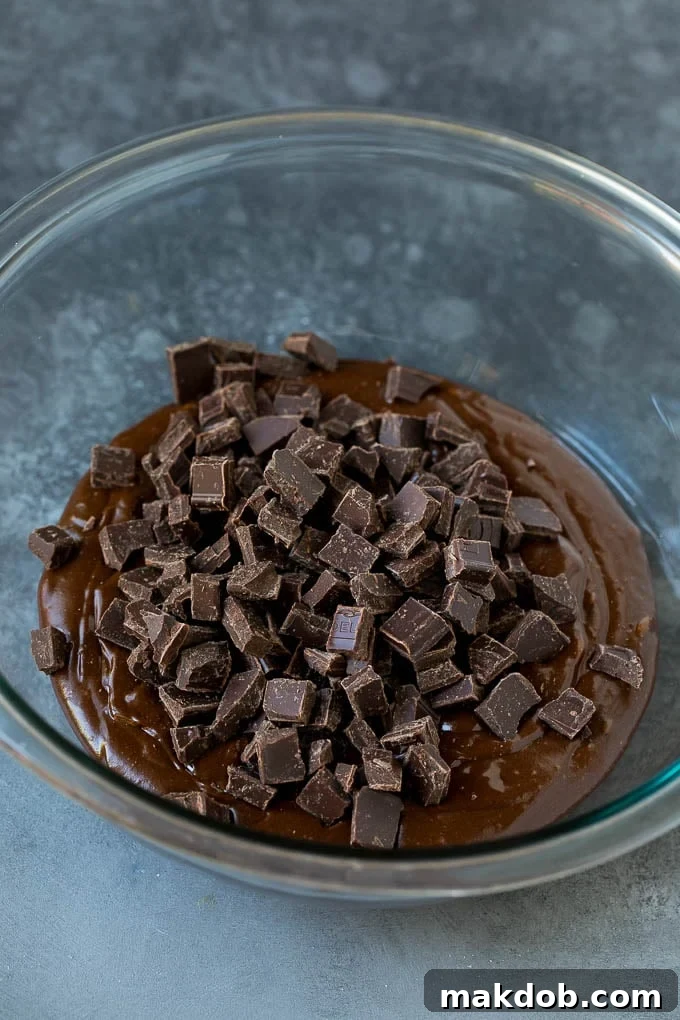 Rich chocolate cookie batter with an abundance of chocolate chunks, ready for chilling.