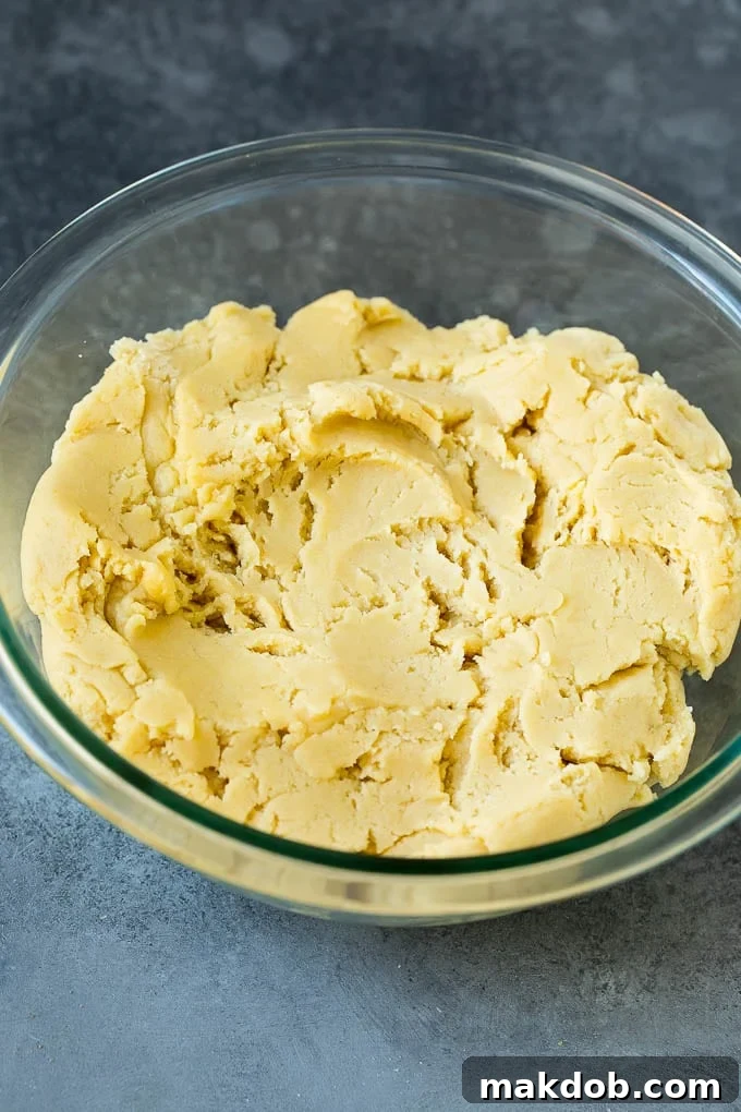 Almond cookie dough in a mixing bowl, ready to be shaped.