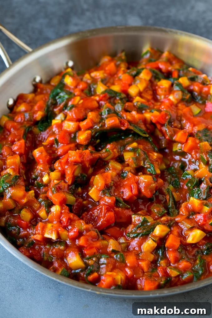 Vegetable Lasagna Recipe | Vegetarian Lasagna #lasagna #vegetarian #veggies #cheese #pasta #dinner #dinneratthezoo A rich marinara sauce filled with an assortment of colorful sautéed vegetables in a large skillet.