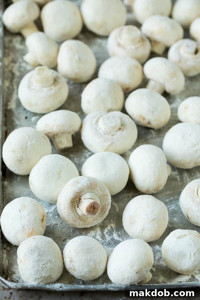 Fried Mushrooms Recipe #mushrooms #appetizer #snack #dinneratthezoo Mushrooms meticulously coated in flour, ready for the next step in the frying process.