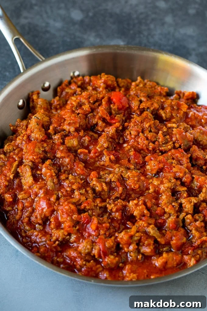 Meat sauce simmering in a skillet, ready for baked ziti.