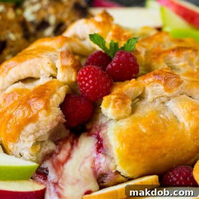 Baked brie cut open with cheese spilling out.
