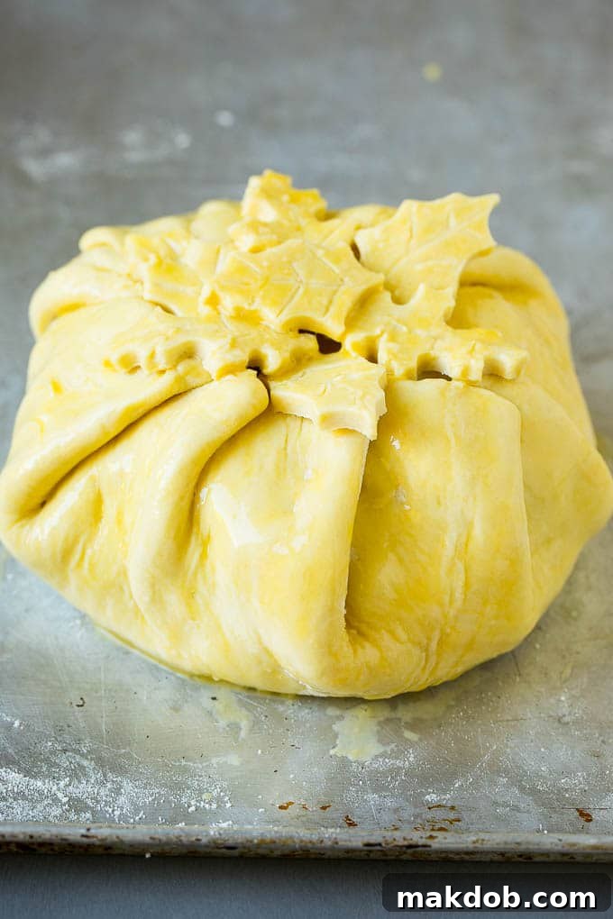Cheese wrapped in puff pastry and topped with egg wash.