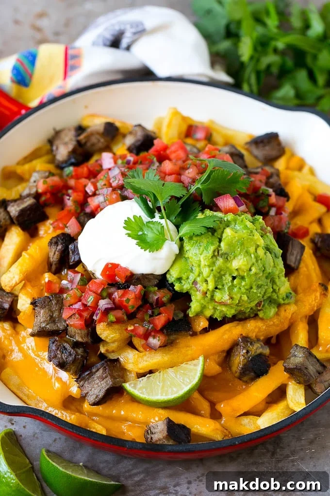 Carne asada fries topped with melted cheese, steak, salsa and guacamole. A vibrant, rich, and irresistible dish perfect for any gathering.