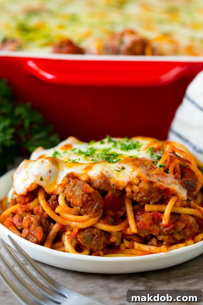 Delicious Serving of Baked Spaghetti A generous serving of baked spaghetti, showcasing the layers of pasta, meat sauce, and melted cheese, ready to be enjoyed.