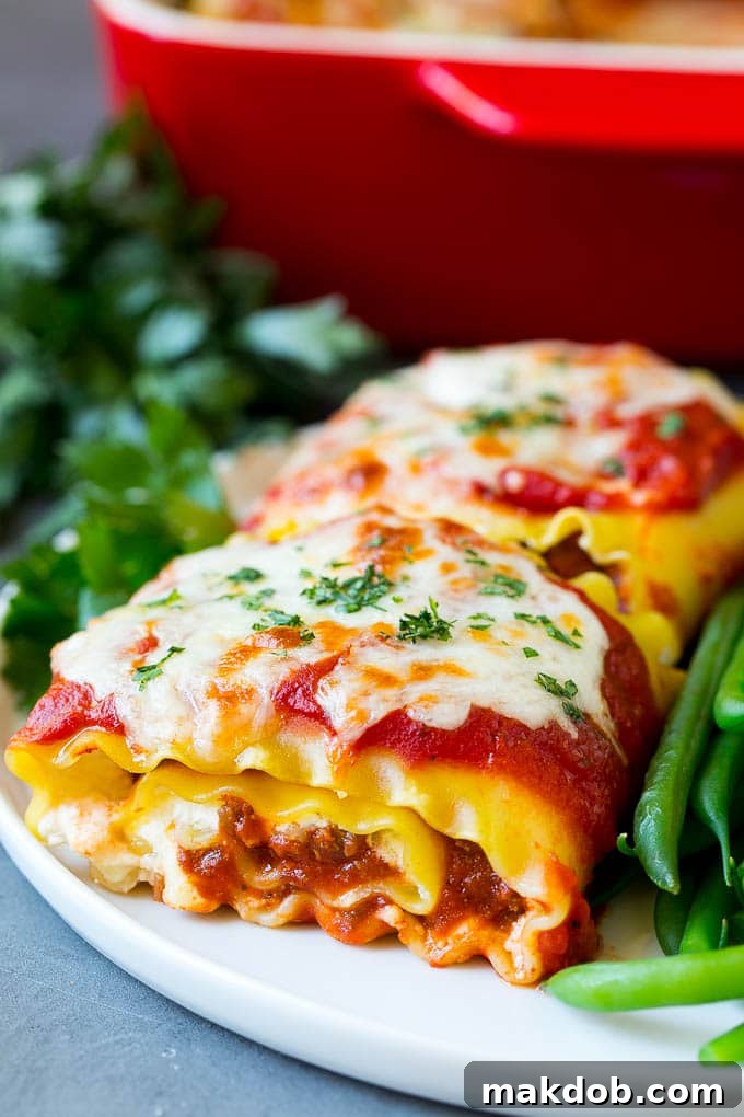 Lasagna roll ups with savory meat sauce and a side of fresh green beans, ready to be served.