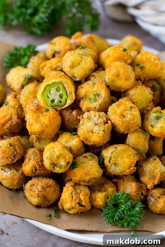 A serving plate of fried okra garnished with parsley.