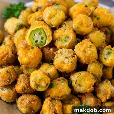 A serving plate of fried okra garnished with parsley.