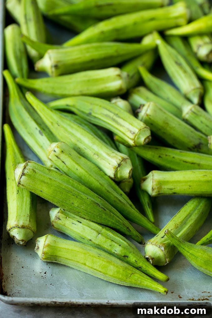 Okra pods on a sheet pan.