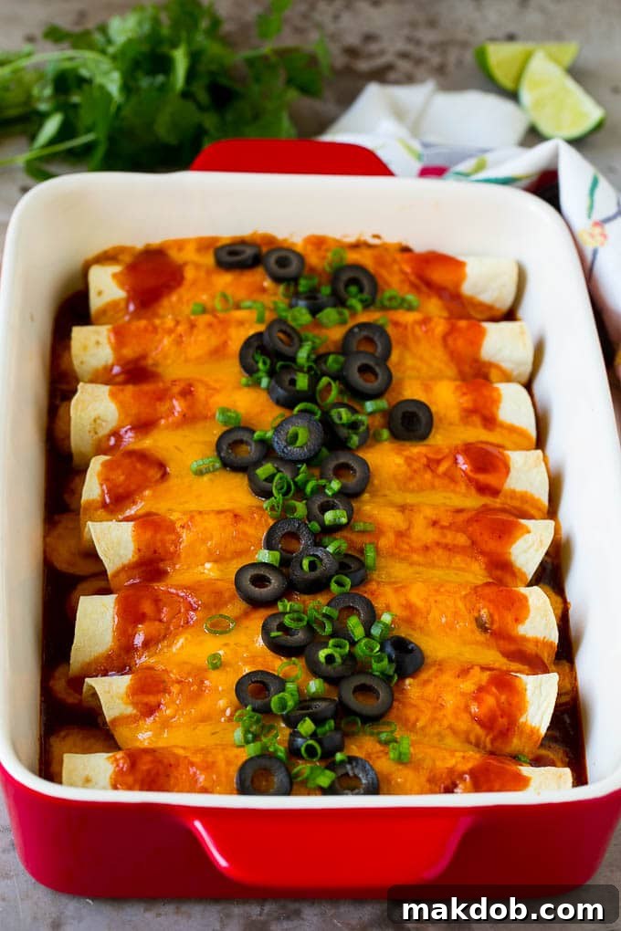 Ultimate Beef Enchiladas 6 Baked beef enchiladas topped with melted cheese, black olives, and green onions, served in a baking dish.