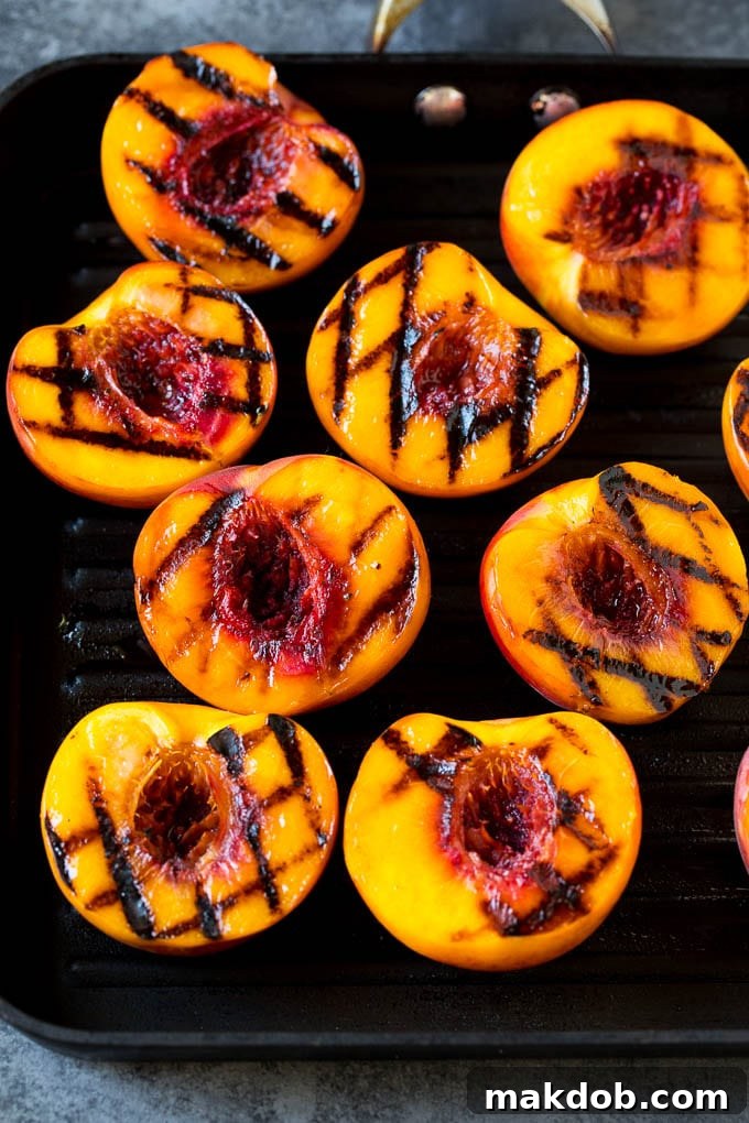 Peach halves cooked on a grill pan.