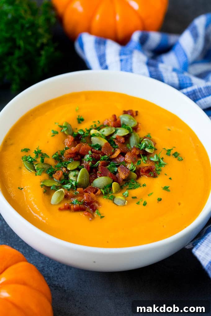 Exquisite Roasted Pumpkin Soup with Smoky Bacon A bowl of roasted pumpkin soup topped with crispy bacon pieces, fresh parsley, and toasted pumpkin seeds, presented beautifully for a comforting autumn meal.