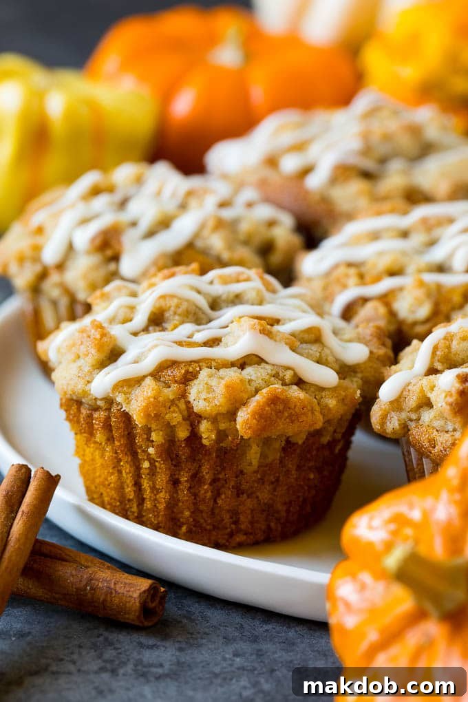 Pumpkin Streusel Muffins Close-up A close-up of a plate with several pumpkin streusel muffins, highlighting their fluffy texture and golden topping.