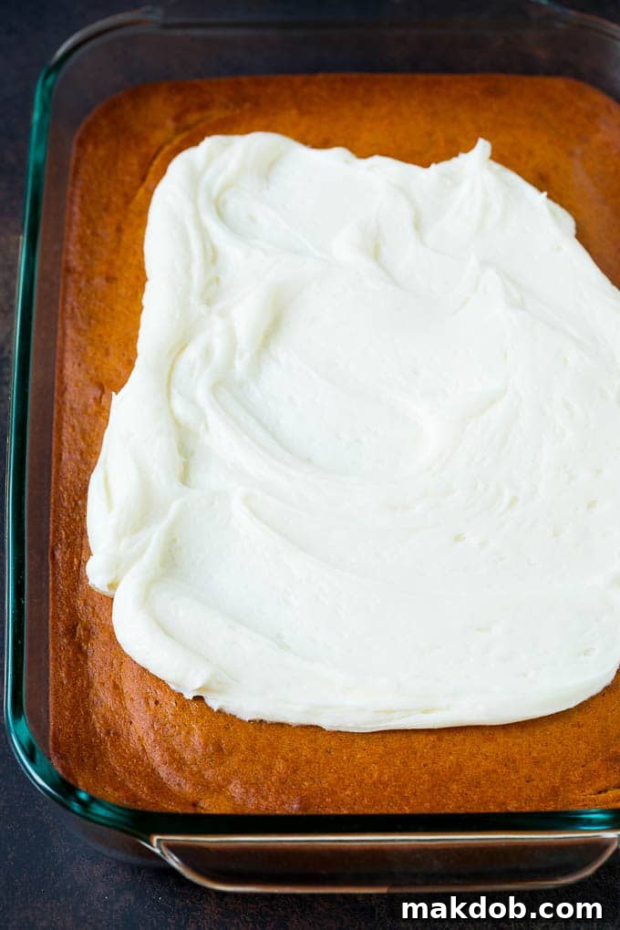 The finished pumpkin cake base, frosted and decorated, ready for serving.