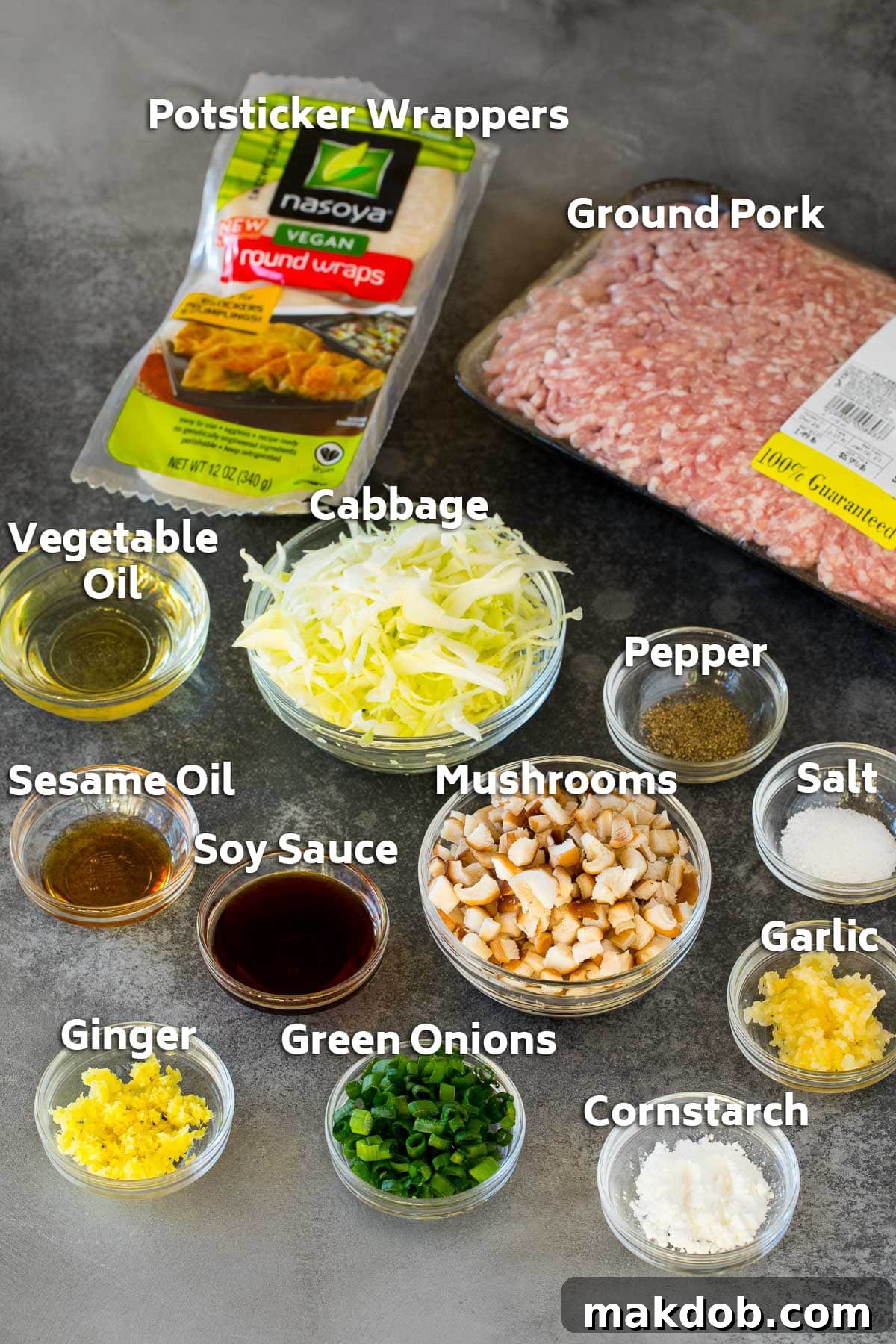 Crispy Bottom Potstickers 3 Ingredients laid out on a table to make dumplings, including ground pork, various vegetables, and essential seasonings and spices.