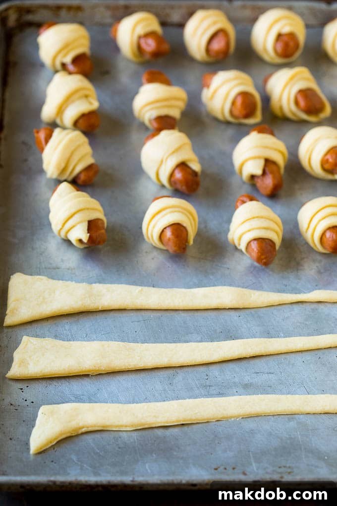 Strips of crescent dough on a sheet pan.
