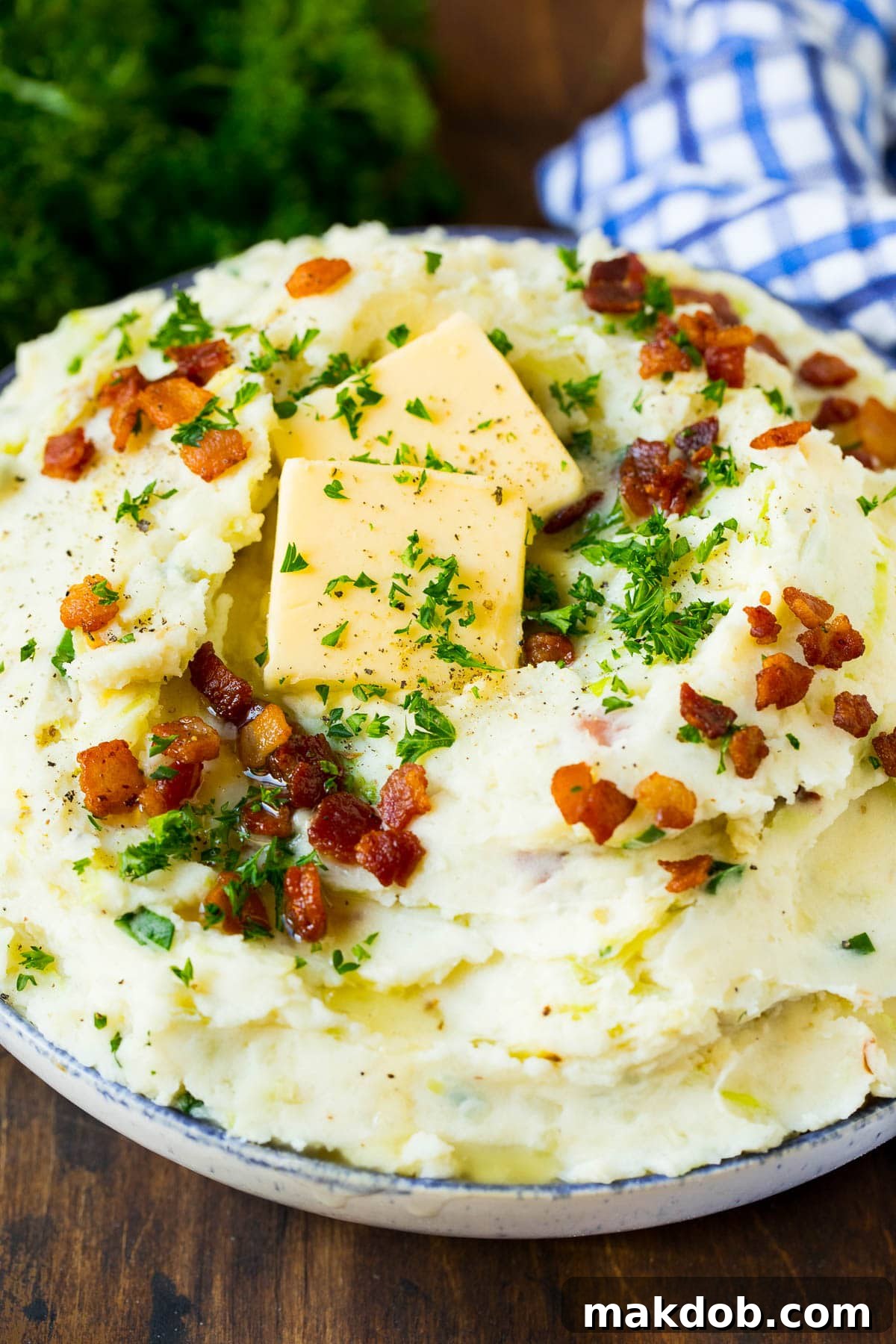 Colcannon Recipe | Mashed Potatoes #potatoes #cabbage #bacon #sidedish #stpatricksday #dinner #dinneratthezoo A serving bowl of colcannon topped with butter and herbs.