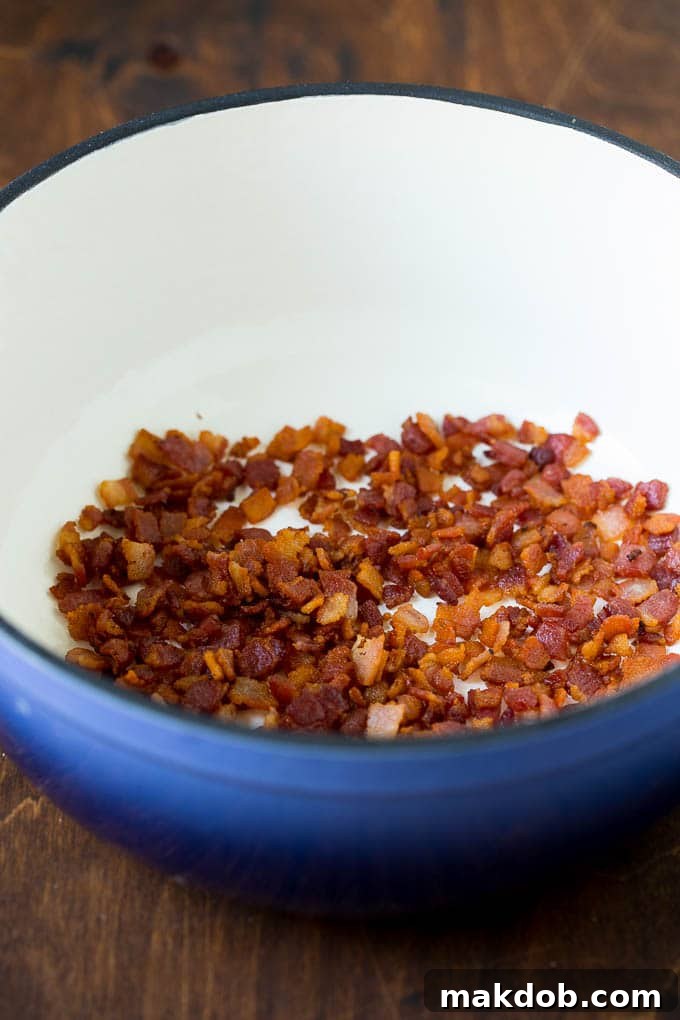 Bacon cooking in a pot, ready to be removed for crispness.
