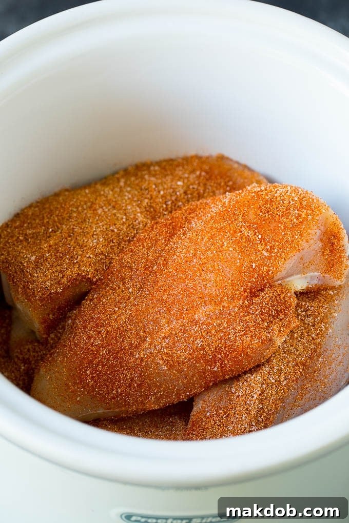 Chicken breasts coated in homemade spice rub ready for the crockpot.