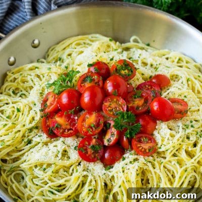 Aromatic Garlic Herb Angel Hair 2 Garlic and herb angel hair pasta topped with fresh tomatoes.