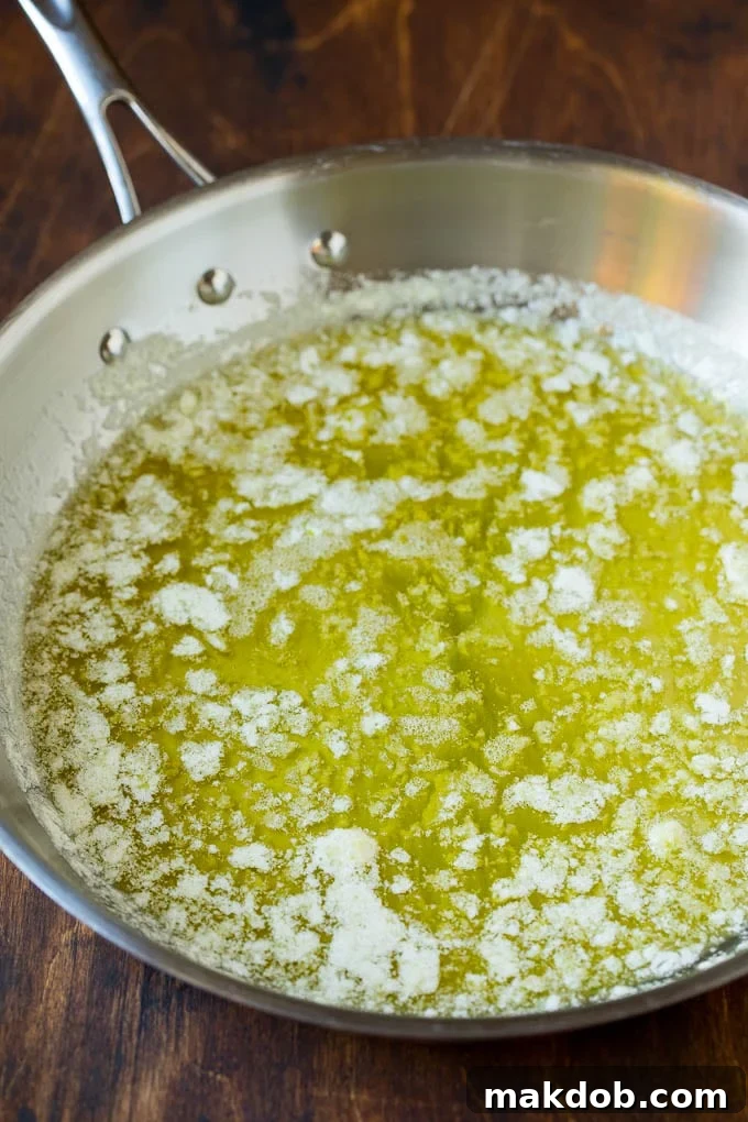 Garlic and Herb Angel Hair Pasta #pasta #garlic #sidedish #dinner #dinneratthezoo Melted butter with garlic and olive oil in a pan.