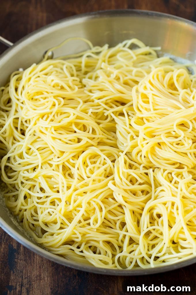 Garlic and Herb Angel Hair Pasta #pasta #garlic #sidedish #dinner #dinneratthezoo Pasta in a pan with garlic and butter.