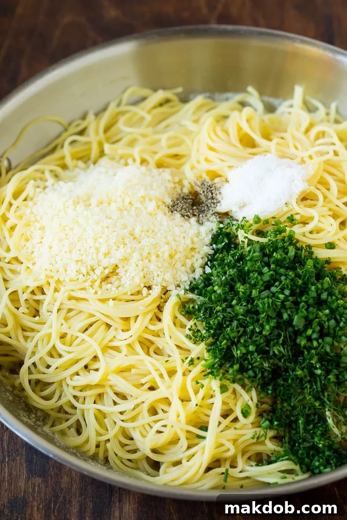 Garlic and Herb Angel Hair Pasta #pasta #garlic #sidedish #dinner #dinneratthezoo Pasta topped with herbs, cheese, salt and pepper.
