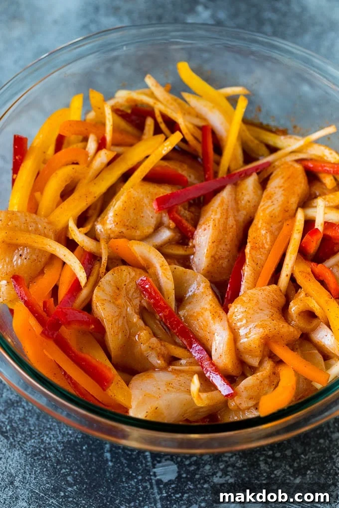 Chicken Fajita Marinade Recipe | Chicken Fajitas #chicken #fajitas #marinade #dinner #dinneratthezoo Sliced chicken and vegetables coated in fajita marinade, ready for cooking.
