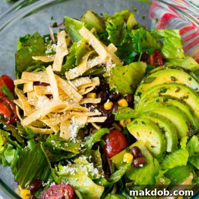 Mexican salad with lettuce, corn, beans and tomato, tossed in a lime dressing.