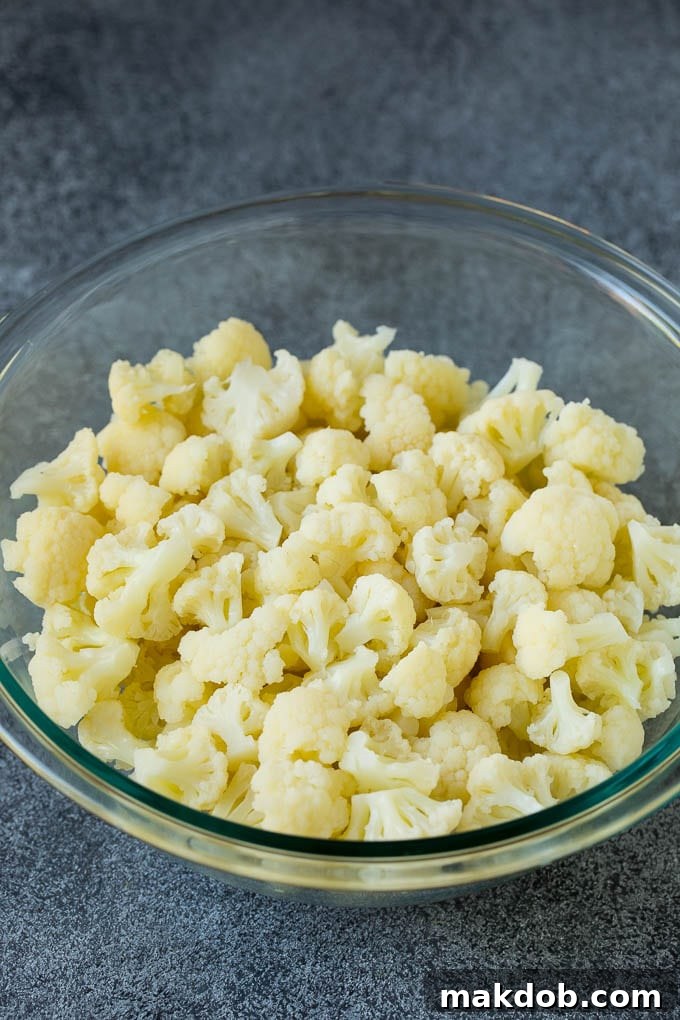 Steamed cauliflower florets in a bowl, ready for salad preparation.