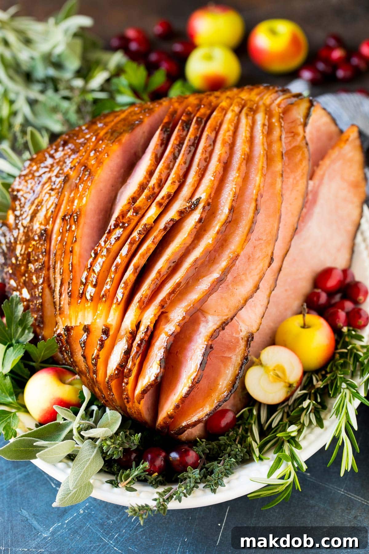 The Secret to a Succulent Ham 2 How to cook a ham results of a glazed ham garnished with fruit. A perfectly baked ham sits on a serving platter, glistening with a rich glaze and garnished with fresh cranberries and herbs, ready to be carved and enjoyed.