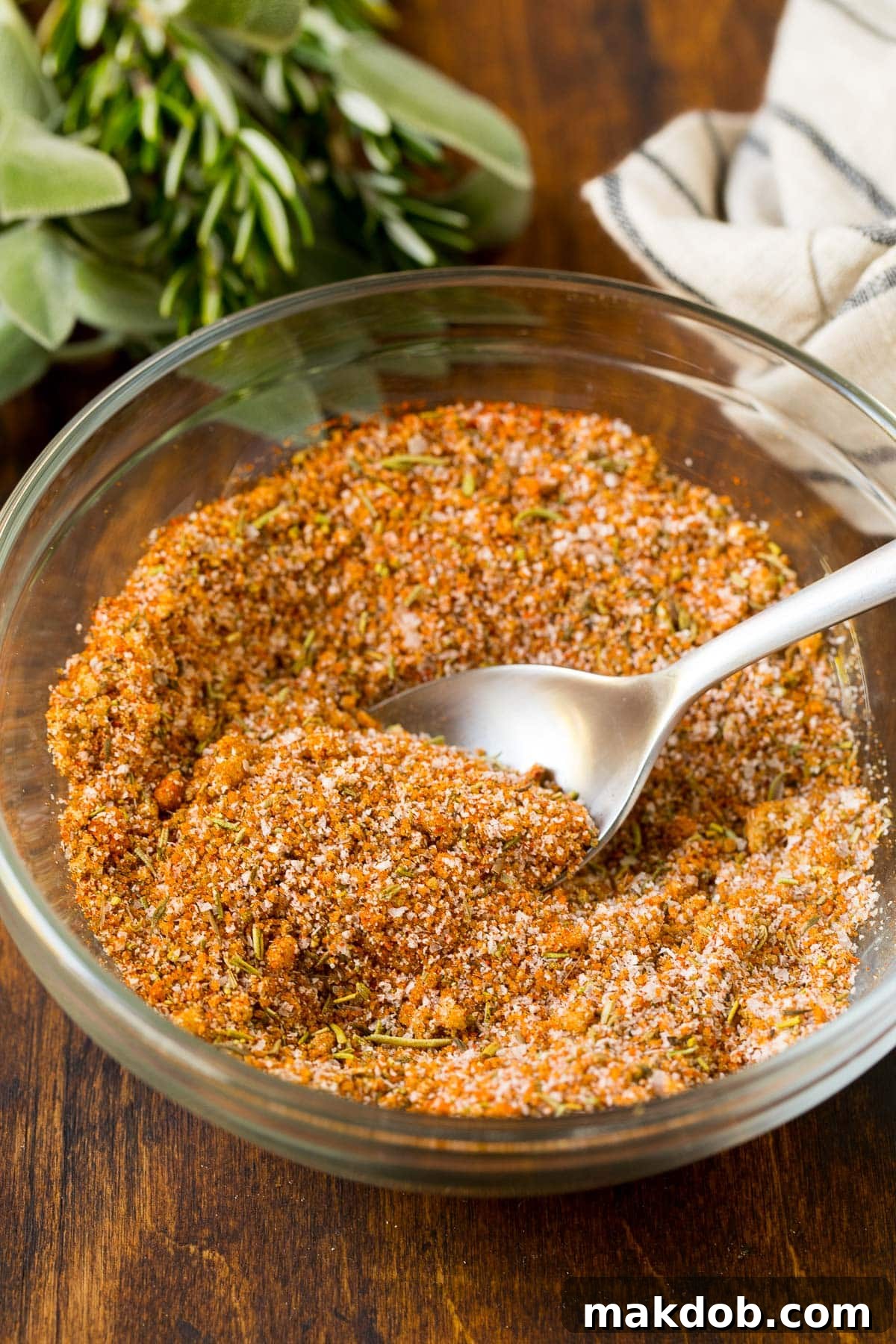 Ultimate Turkey Rub 5 A pristine bowl of finely blended savory spice mix, with a small silver spoon resting within, highlighting the perfect texture of the homemade turkey rub.