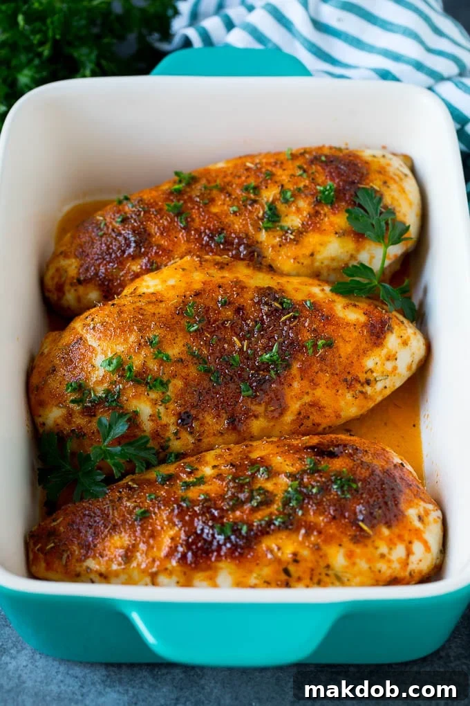 Baked chicken breast topped with fresh chopped parsley.