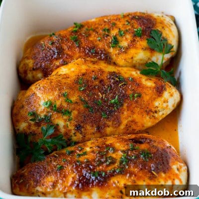 Baked chicken breast topped with fresh chopped parsley.