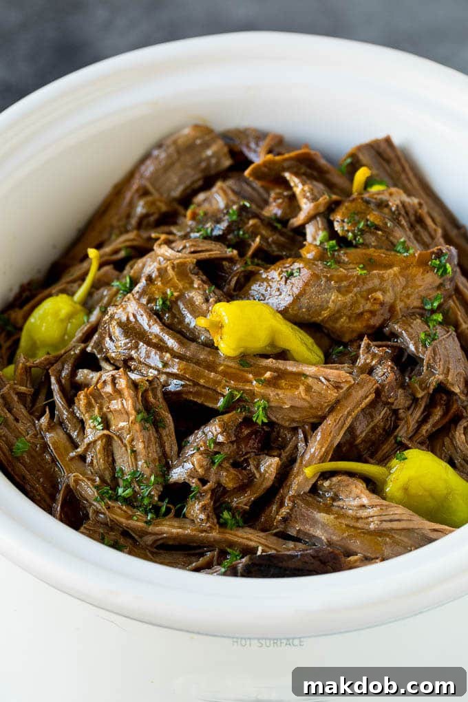 Mississippi Pot Roast: Tender Beef Slow Cooked to Perfection A slow cooker filled with shredded Mississippi pot roast, ready to serve.